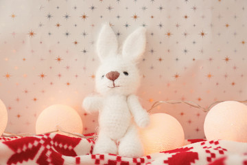 Small toy and Christmas garland on blanket