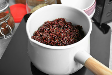 Saucepan with boiled rice in kitchen