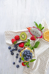 Mason jar with fruits and berries on table
