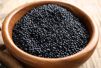 Bowl with black lentils, closeup