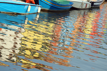 Fototapeta na wymiar Burano Island in Italy Reflection of colorful houses and boats