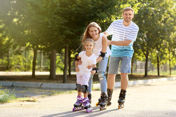 Family rollerskating in park