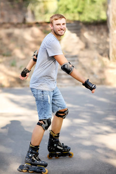 Young man rollerskating in park