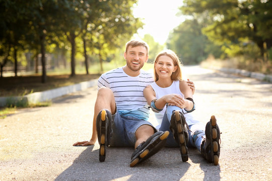 Young couple with roller skates in park