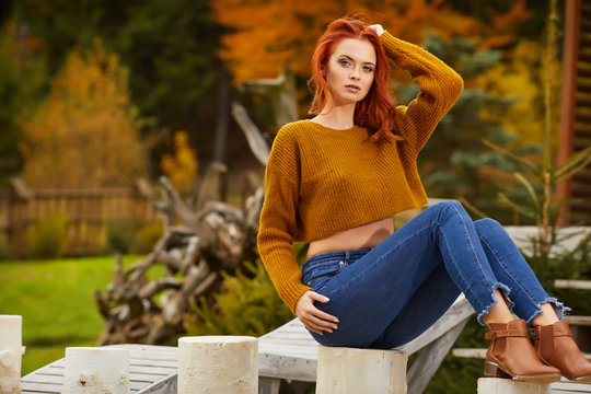 Ginger Woman In Autum Clothes  On The Sunset