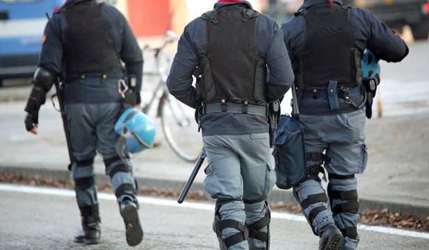 policemen with anti-bulletproof jacket patrol the streets of the