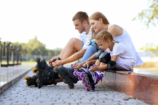 Family with roller skates in park