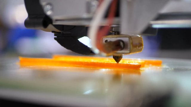 Printing with Plastic Wire Filament on 3D Printer. Automatic three dimensional 3d printer performs product creation. Modern 3D printing or additive manufacturing and robotic automation technology