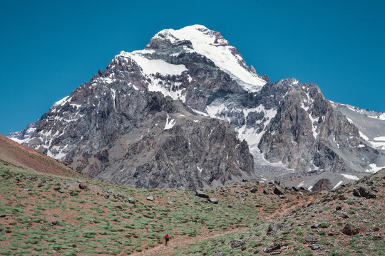Hiker in front of a mountain.