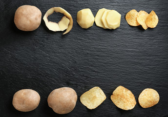 Raw potatoes and chips on dark background