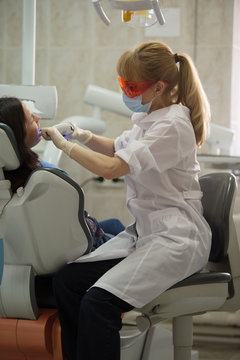 Dentist curing patient