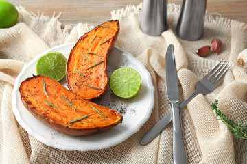 Plate with cooked sweet potato on table