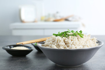 Dish with white rice on table