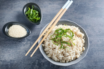Dish with white rice on table