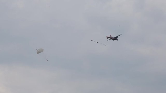 Paratroopers jump out of the plane. Air show.