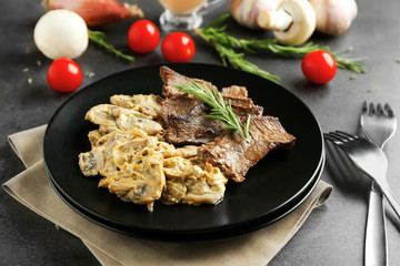 Plate with steak Diane on table
