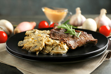 Plate with steak Diane on table