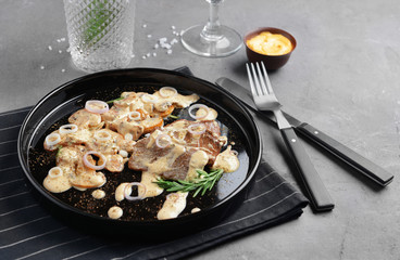 Plate with steak Diane on table