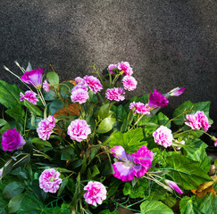 Artificial flowers bouquet on stone background, copy space