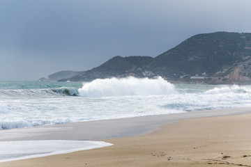 Large waves hitting the shores beach in coastal town