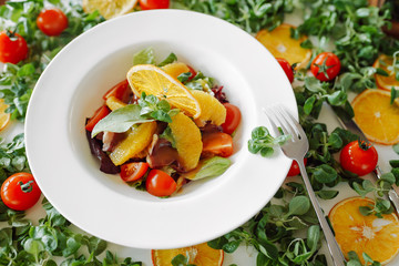 salad in oranges, tomatoes and bacon