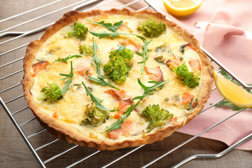 Tasty salmon quiche on cooling rack