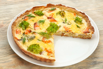 Tasty salmon quiche on plate