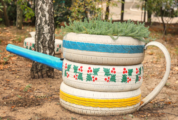 Old tires used as flowerbed outdoors