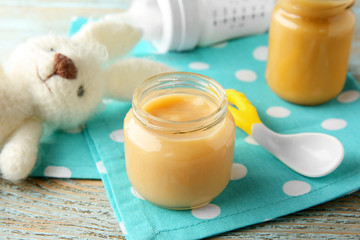 Jar of tasty baby food on table