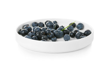 Plate with fresh acai berries, isolated on white