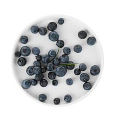 Plate with fresh acai berries, isolated on white