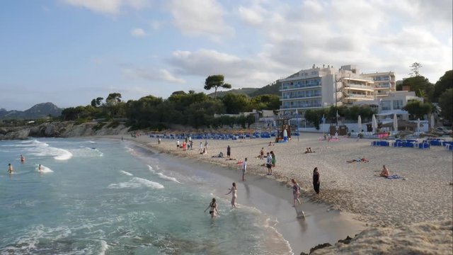 Tourists swimming at the Son Moll beach in the evening in Cala Ratjada Mallorca Spain