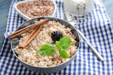 Tasty oatmeal in bowl for breakfast on table