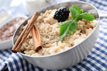 Tasty oatmeal in bowl for breakfast on table