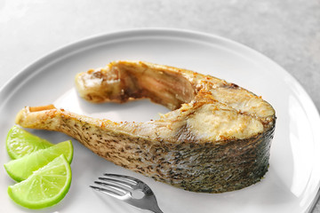 Ceramic plate with fried fish steak, closeup
