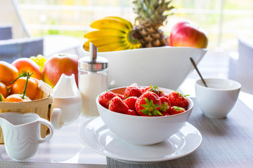 Strawberries in a white dish. Breakfast from fruit.