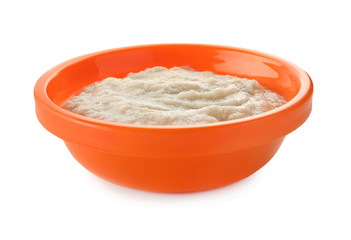 Bowl with porridge for baby on white background