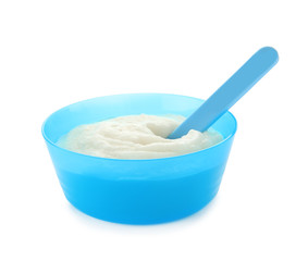 Fototapeta na wymiar Bowl with porridge for baby on white background