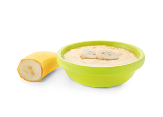 Bowl with porridge for baby on white background