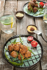 Plate with tasty sausage cheese balls on table