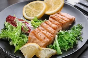Slice of delicious salmon on plate, close up