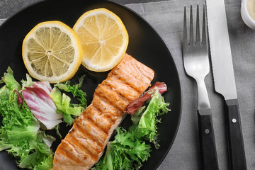 Slice of delicious salmon on plate, close up