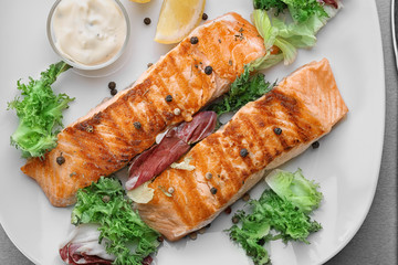 Delicious slices of salmon on plate, close up