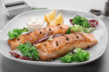 Delicious slices of salmon on plate, close up