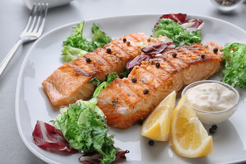 Delicious slices of salmon on plate, close up