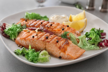 Delicious slices of salmon on plate, close up