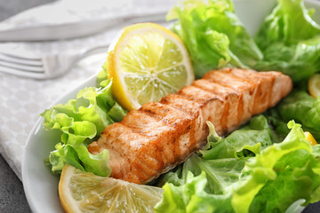 Slice of delicious salmon on plate, close up