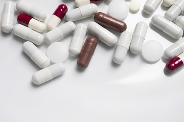 red, white, brown, orange colored pills in white backround