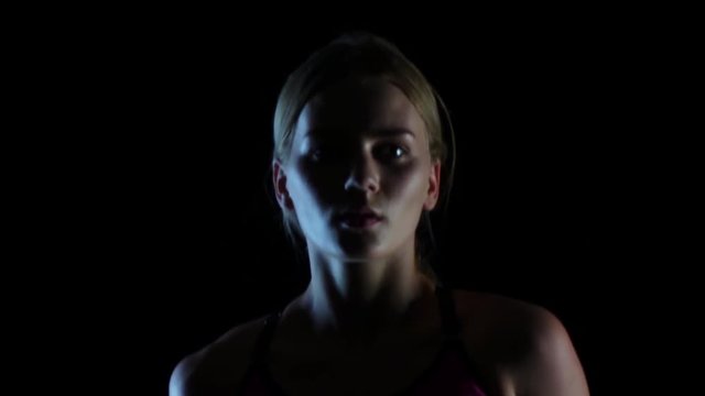 Look graceful running girl on a black screen. Slow motion. Close up
