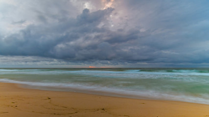 Fototapeta na wymiar Cloudy and Overcast Daybreak at the Beach